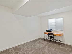 Office with baseboards and carpet flooring