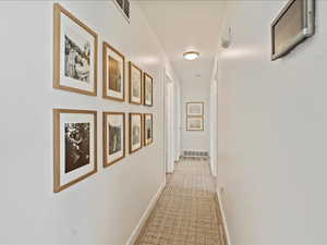 Corridor featuring baseboards