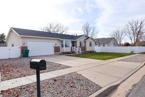 Ranch-style house featuring concrete driveway, brick siding, an attached garage, roof with shingles, and a gate