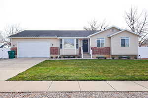 Single story home with brick siding, driveway, an attached garage, and a shingled roof