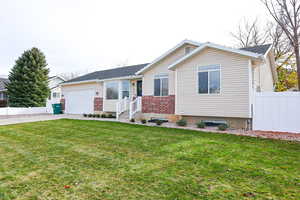 Ranch-style home with concrete driveway, a garage, and brick siding