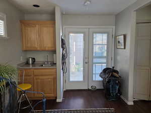 Untry to Casita with french doors, healthy amount of natural light, a wt bar, and wood finished floors