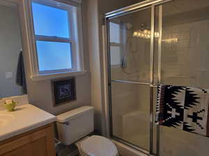 Full bath featuring a stall shower and vanity