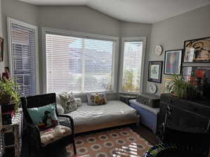 2nd Bedroom featuring a textured ceiling and lofted ceiling