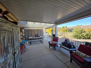 View of back, covered patio featuring outdoor lounge area