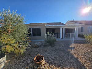 Back of house with stucco siding, a patio, a pergola, a tile roof, and an outdoor fire pit