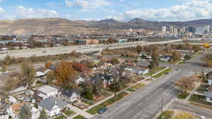 Aerial view of property's location with a mountain backdrop and nearby suburban area