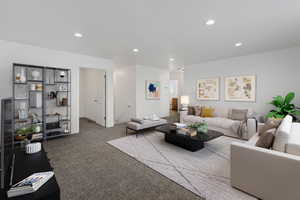 Carpeted living room featuring recessed lighting