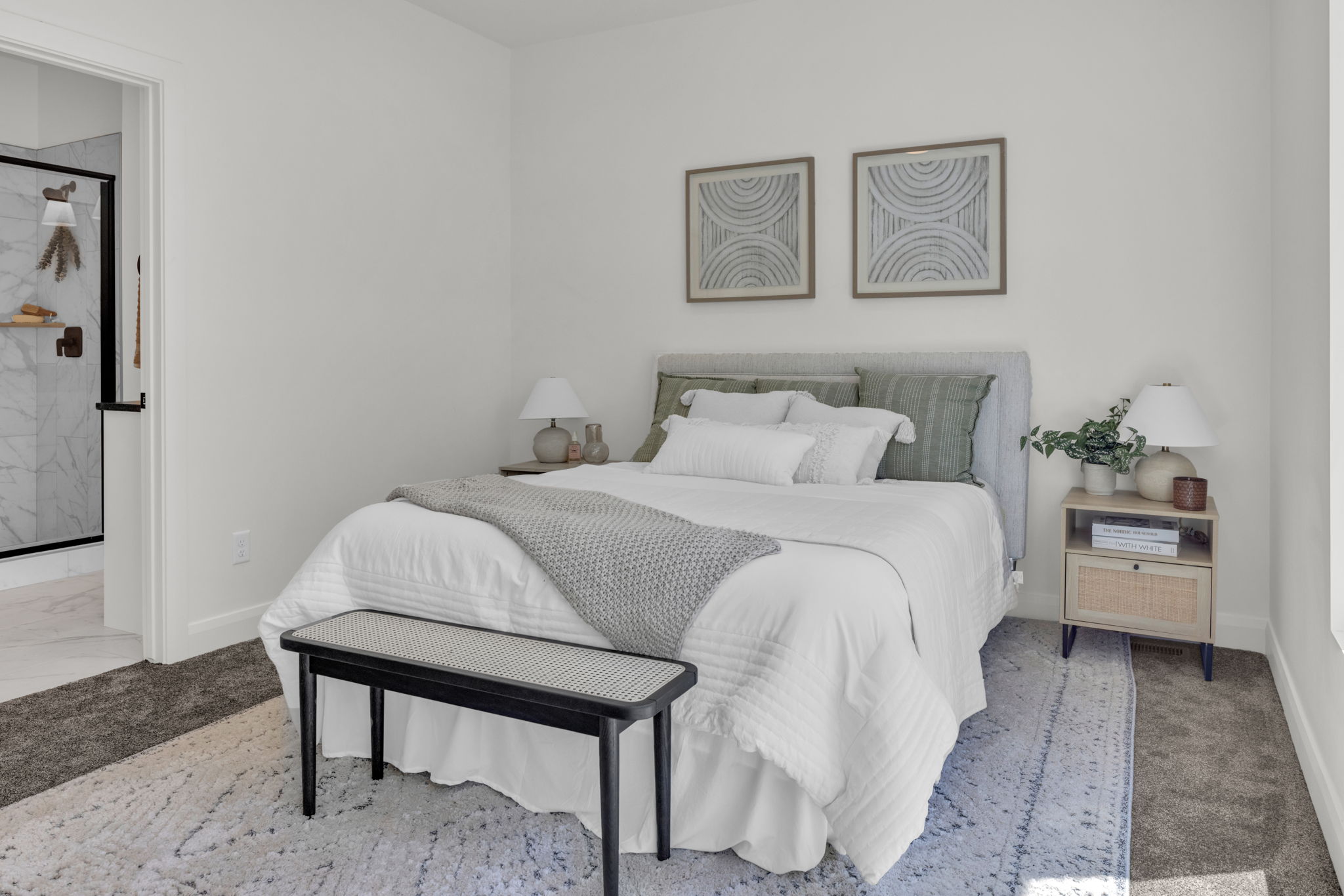 Bedroom featuring ensuite bath and marble look tile flooring