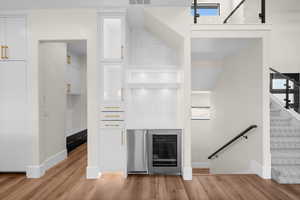 A stylish bonus bar area, complete with a beverage center and pebbled ice machine—perfectly designed to keep the flow of a modern family seamless and effortless.