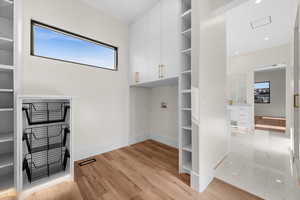 The master closet is a true standout, offering abundant hanging space, two separate drawers, and a thoughtfully designed area for a washer and dryer. A must-see in person to fully appreciate its functionality and elegance.