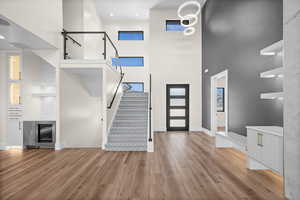 A beautifully designed staircase with sleek glass hand railings, leading gracefully to the upper level.