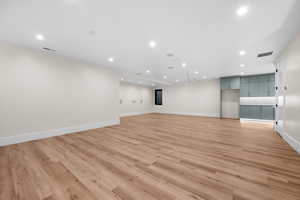 This thoughtfully designed family room is perfect for gathering with family and friends. It features a dedicated movie theater area and a spacious, second kitchen, making entertaining effortless and enjoyable for everyone.