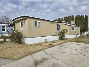 View of home's exterior with a lawn and a central air condition unit
