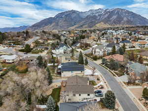 Aerial overview of property's location featuring nearby suburban area and a mountainous background