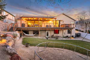 Rear view of property featuring a patio area, a fenced backyard, stucco siding, and stairs