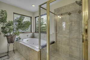 Bathroom with a shower stall, a tub with jets, tile patterned floors, and recessed lighting