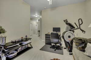 Office space with light colored carpet and ceiling fan