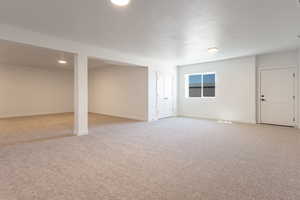 Basement featuring light colored carpet and recessed lighting