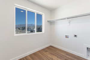 Laundry room with hookup for a washing machine, dark wood-type flooring, electric dryer hookup, and a mountain view