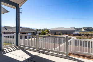 View of patio / terrace with a residential view and an outbuilding