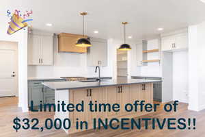 Kitchen with hanging light fixtures, an island with sink, custom exhaust hood, recessed lighting, and light countertops