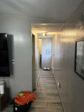 Corridor featuring dark wood-style floors and electric panel