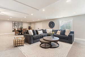 Living room featuring light carpet and recessed lighting