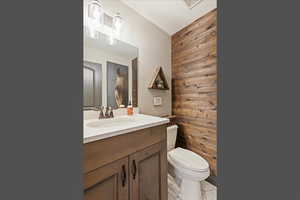 Bathroom featuring vanity and wood walls