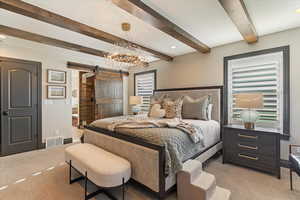 Bedroom with a barn door, light carpet, a chandelier, beamed ceiling, and recessed lighting
