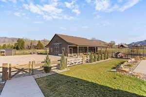View of yard featuring an outbuilding, a mountain view, an exterior structure, a patio area, and driveway