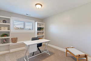Office area featuring light carpet