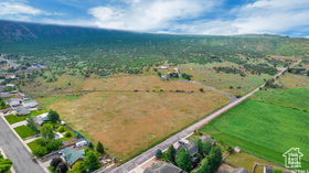 Aerial view of property and surrounding area with rural landscape and a mountainous background