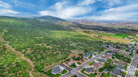 Aerial overview of property's location featuring a mountain backdrop