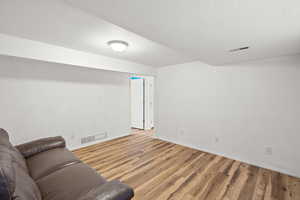 Living room with a textured ceiling and light wood-style floors