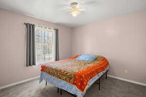 Bedroom with carpet and a ceiling fan