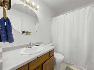 Full bath with vanity and a shower with curtain