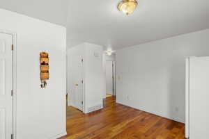 Unfurnished room with hardwood / wood-style flooring and baseboards