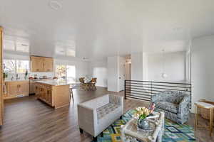 View of entire great room with living area, kitchen, island and semi-formal dining.