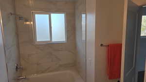 Full bath with tub / shower combination, lots natural light & access to primary bedroom