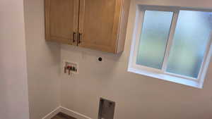 Laundry area with washer hookup, hookup for an electric dryer, and cabinet space