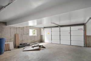 Oversize garage with a new garage door and the Tesla of garage-door openers