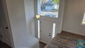 Entryway with light fixture and solid surface flooring