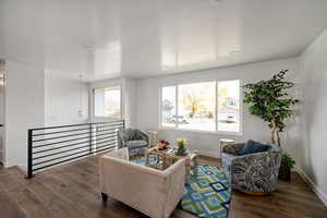 Living area of great room with stairs to entry