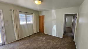 Bedroom 2 featuring dark carpet and baseboards