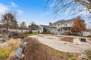 Rear view of house with a chimney and a balcony