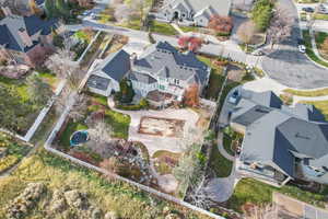 Aerial view of property and surrounding area featuring nearby suburban area