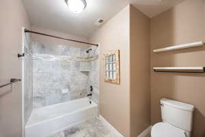 Full bathroom featuring shower / tub combination and toilet