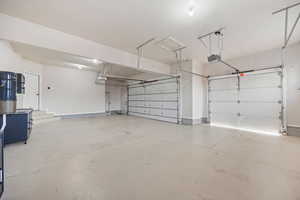 Garage featuring a central vacuum unit and a garage door opener