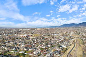 Aerial overview of property's location featuring nearby suburban area and mountains